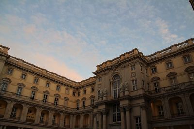 Low angle view of building against cloudy sky