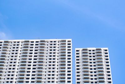 Low angle view of modern building against clear blue sky