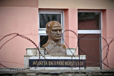 Close-up of statue against building