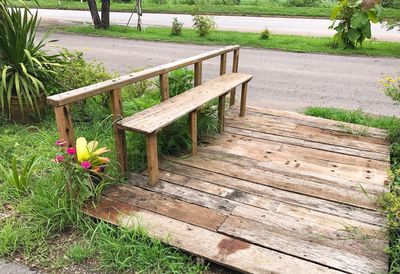 Empty wooden bench in grass