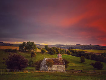 Scenic view of field against sky during sunset