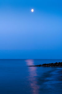 Scenic view of sea against sky at night