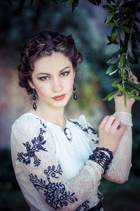 Portrait of young woman standing outdoors