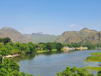 Scenic view of lake and mountains against clear sky