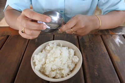 Midsection of man preparing food on table