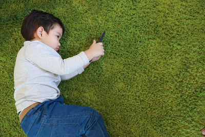 High angle view of man using mobile phone in field