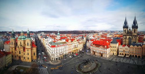 High angle view of city street against cloudy sky