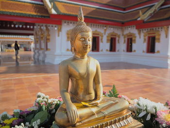 Statue of buddha against building