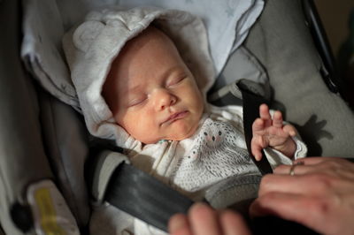 Portrait of newborn baby girl in baby stroller