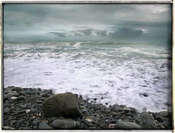 Scenic view of sea against cloudy sky