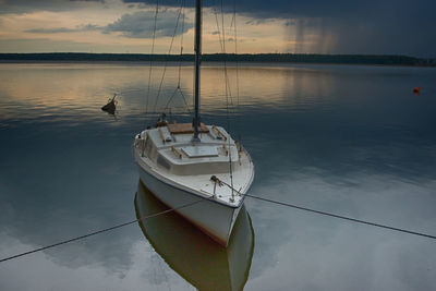 Sailboats in marina at sunset