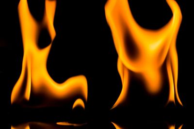 Close-up of lit candle in dark room