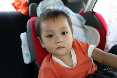 Portrait of cute boy in car