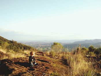 Man standing on mountain against sky