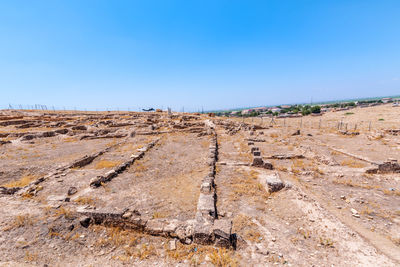 Scenic view of field against clear blue sky