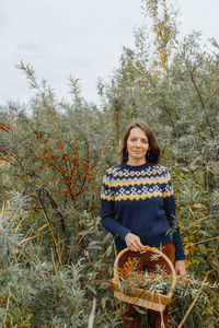 Portrait of smiling young woman sitting on field