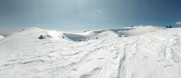 Scenic view of snow covered mountains against sky