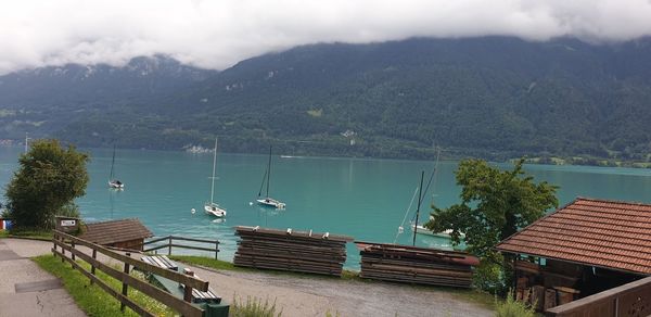 High angle view of lake by mountain against sky