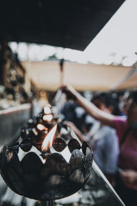 Close-up of lit candles in temple