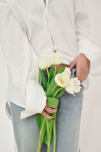 Midsection of woman holding bouquet