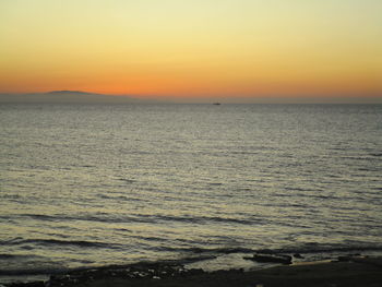 Scenic view of sea against orange sky