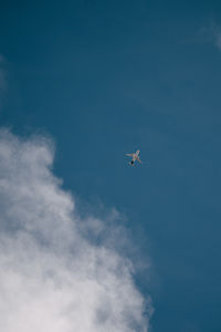 Low angle view of airplane flying in sky