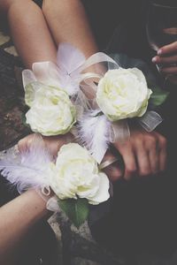 Low section of woman holding rose bouquet