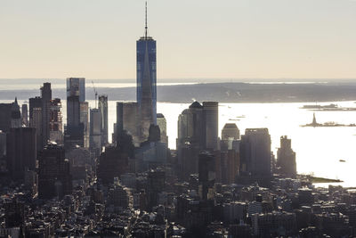 High angle view of cityscape and one world trade center against sky during sunset