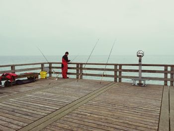 Woman standing on pier