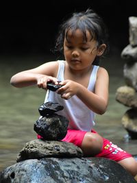 Side view of young woman using mobile phone