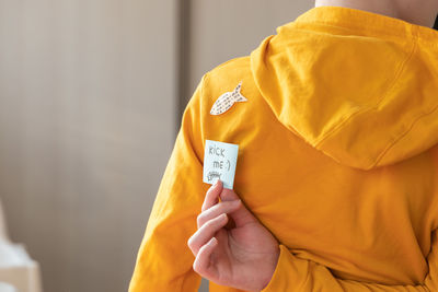 Midsection of woman holding thermometer