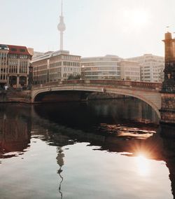 Bridge over river with city in background