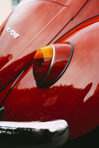 Close-up of red car on side-view mirror