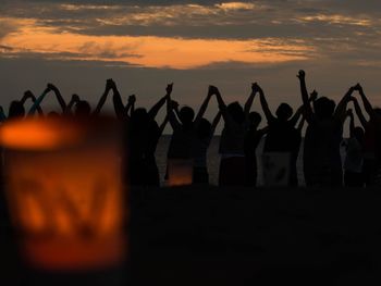 Silhouette of people at sunset