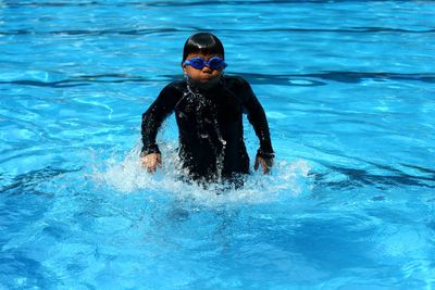 Boy swimming in pool