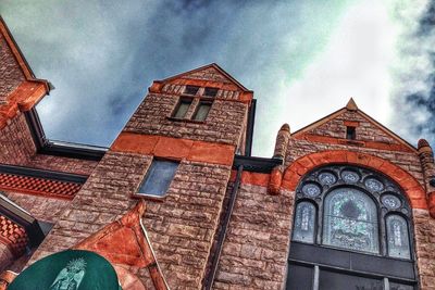 Low angle view of building against cloudy sky