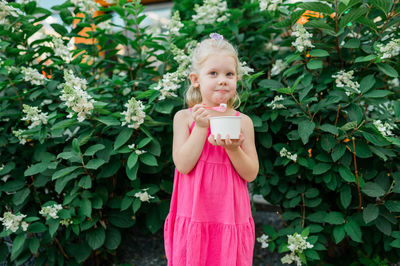 Portrait of young woman holding flower