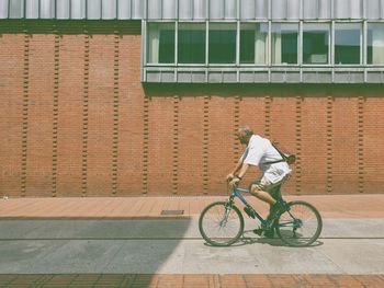 Man riding bicycle outside building