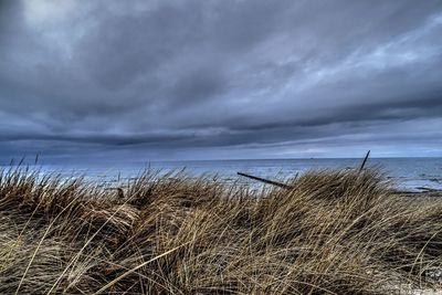 Scenic view of sea against cloudy sky