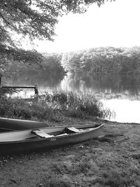 Boats moored in lake against sky