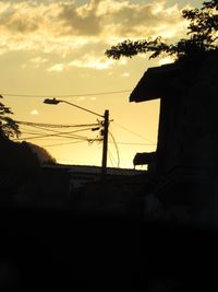 Low angle view of silhouette built structures at sunset