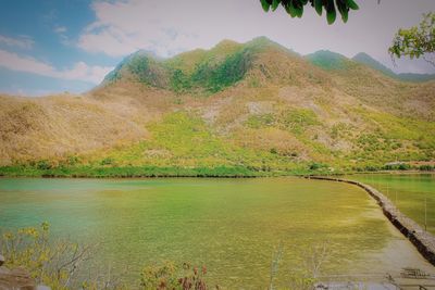 Scenic view of lake and mountains against sky