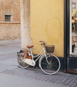 Bicycle parked on street against building