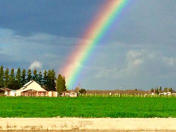 Rainbow over landscape against sky