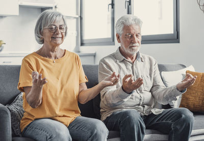 Portrait of senior friends sitting at home