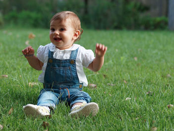 Boy playing on grassy field