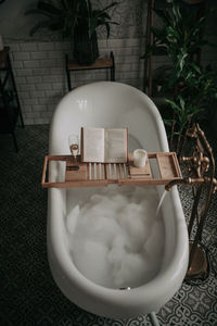 Luxury interior of big bathroom at modern african style with oval bathtub in natural lighting