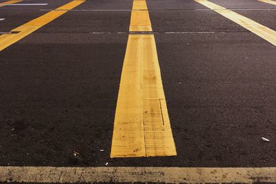 High angle view of yellow arrow symbol on road