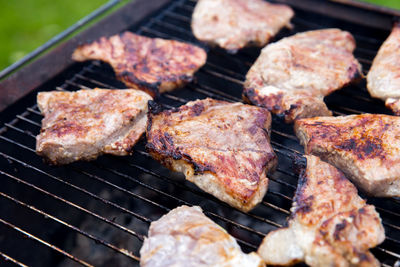 High angle view of meat cooking on barbecue grill