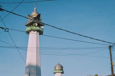 Low angle view of communications tower against sky